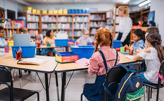 This image shows a group of students in a classroom, whose attendance CommunityPass's afterschool program management software can track.